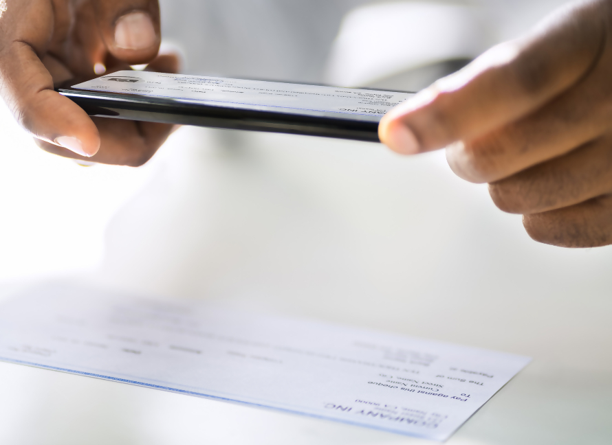 Mobile phone user depositing a check